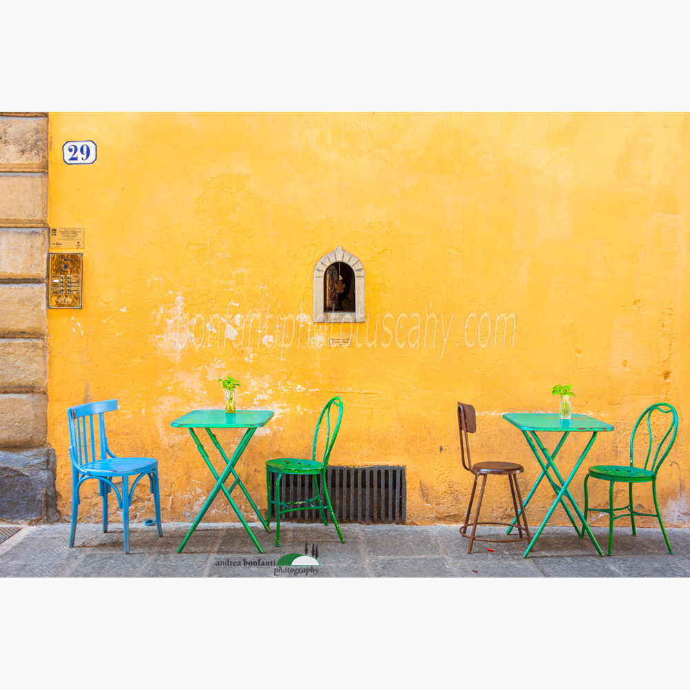 a wine window and colorful tables in via santo spirito.jpg