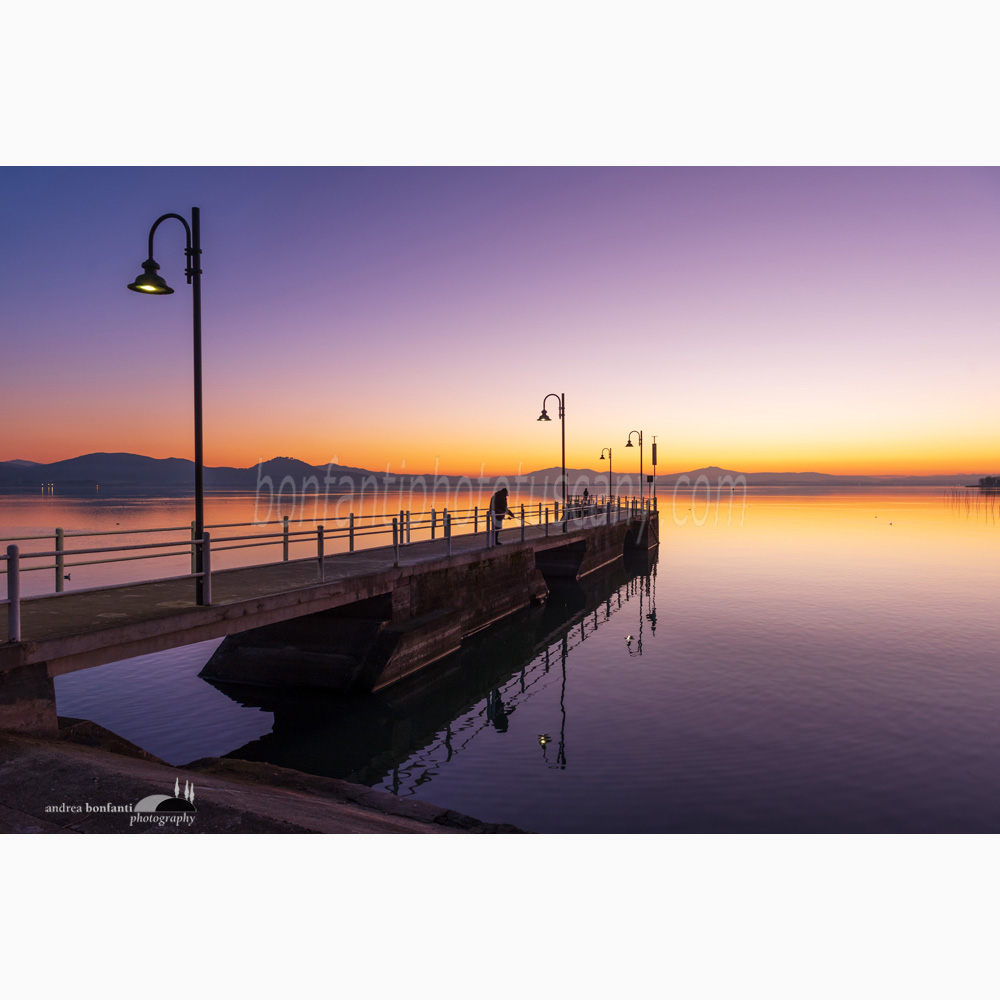 a lone fisherman at dusk at san feliciano sul trasimeno.jpg