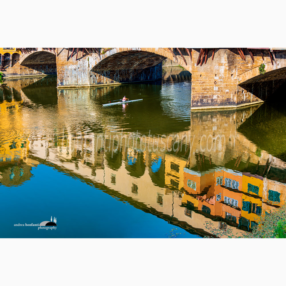 a canoeist rows under the ponte vecchio in florence.jpg