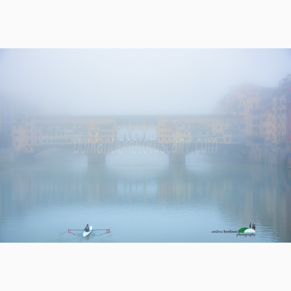 ponte vecchio in a foggy morning with a rower.jpg