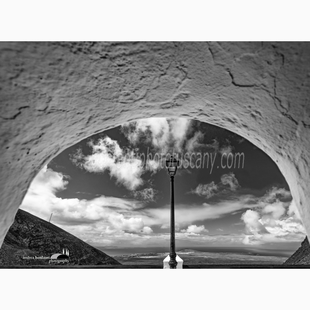 an arch framing the landscape in the village of Femès.jpg