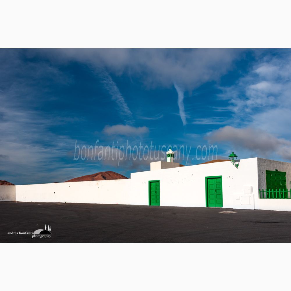 a large square in Mancha Blanca with some red volcanoes in the background.jpg