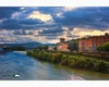 a stormy view of the river arno in florence from ponte alle grazie